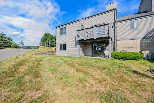 578 Pilgrim Hbr Unit 578, Wallingford, CT 06492 - rear view of house with a lawn, a chimney, and a deck
