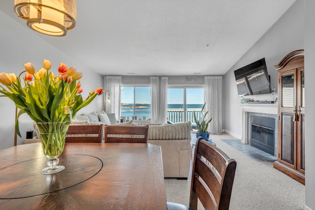 5 Mansfield Grove Rd Apt 341, East Haven, CT 06512 - dining room with a tile fireplace, lofted ceiling, and carpet flooring