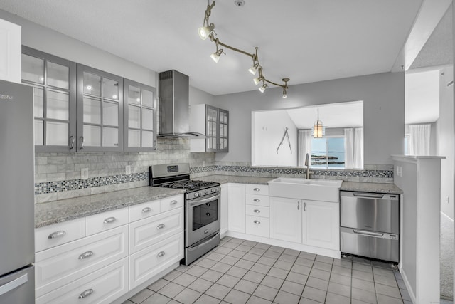 5 Mansfield Grove Rd Apt 341, East Haven, CT 06512 - kitchen featuring appliances with stainless steel finishes, wall chimney range hood, glass insert cabinets, and tasteful backsplash