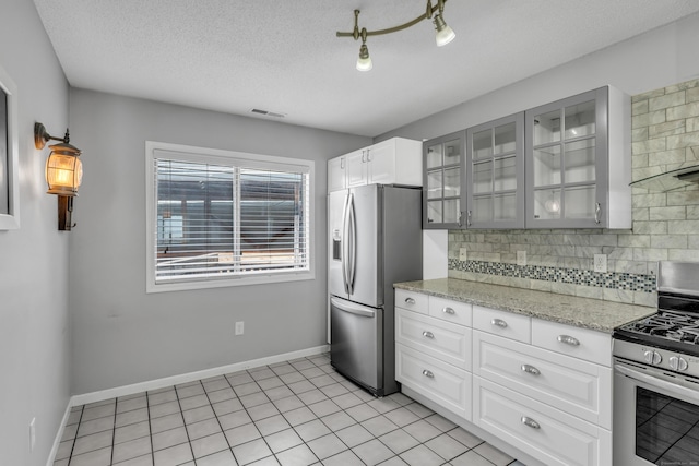 5 Mansfield Grove Rd Apt 341, East Haven, CT 06512 - kitchen featuring appliances with stainless steel finishes, tasteful backsplash, glass insert cabinets, light stone countertops, and white cabinetry