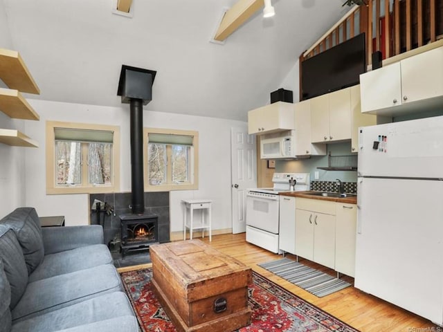 35 Rayfield Rd, Westport, CT 06880 - living room with a wood stove, light wood finished floors, and vaulted ceiling