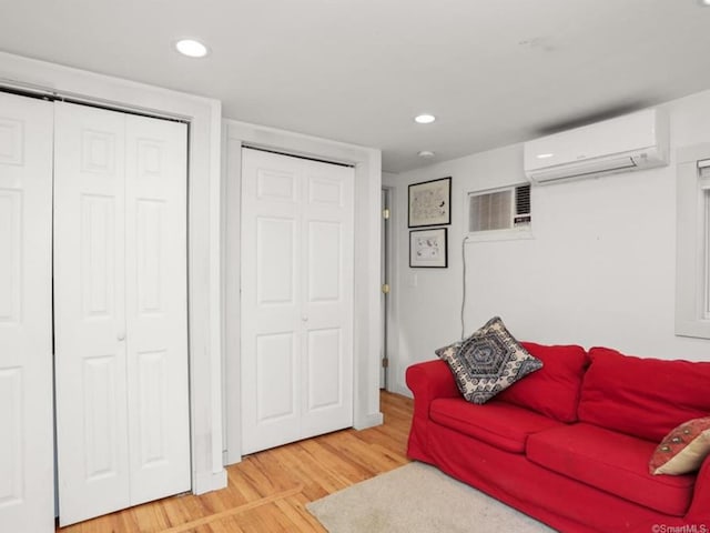 35 Rayfield Rd, Westport, CT 06880 - living area with a wall mounted air conditioner, light wood-style flooring, a wall unit AC, and recessed lighting