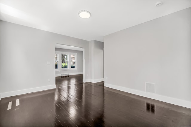 222 Wakelee Ave, Ansonia, CT 06401 - spare room featuring a smoke detector, arched walkways, and wood finished floors