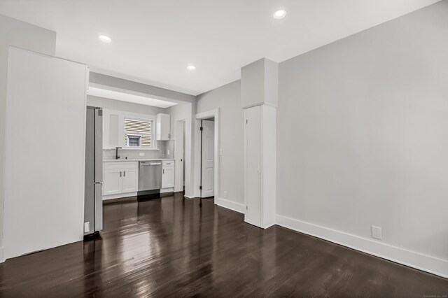222 Wakelee Ave, Ansonia, CT 06401 - unfurnished living room featuring dark wood-type flooring and recessed lighting