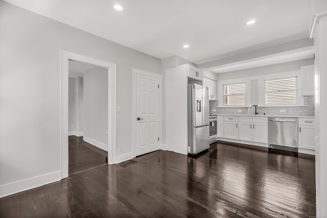 222 Wakelee Ave, Ansonia, CT 06401 - kitchen featuring stainless steel appliances, dark wood finished floors, decorative backsplash, white cabinetry, and light countertops