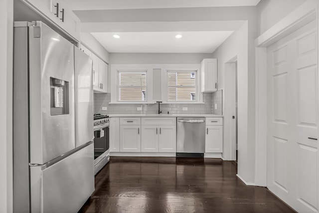 222 Wakelee Ave, Ansonia, CT 06401 - kitchen with stainless steel appliances, light countertops, white cabinetry, tasteful backsplash, and recessed lighting
