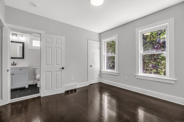 222 Wakelee Ave, Ansonia, CT 06401 - unfurnished bedroom featuring dark wood-style floors and ensuite bath