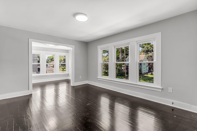 222 Wakelee Ave, Ansonia, CT 06401 - unfurnished living room with baseboards and dark wood-style flooring