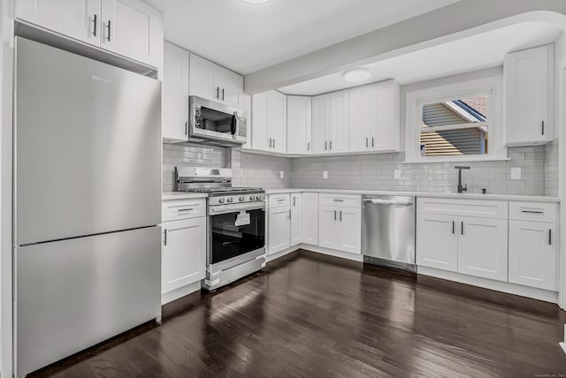 222 Wakelee Ave, Ansonia, CT 06401 - kitchen with stainless steel appliances, light countertops, decorative backsplash, and white cabinets