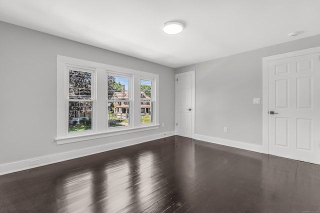 222 Wakelee Ave, Ansonia, CT 06401 - spare room featuring baseboards and dark wood-type flooring