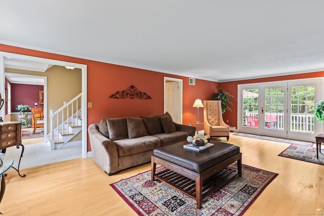 4 Adams Rd, Simsbury, CT 06089 - living room featuring light wood-style floors, ornamental molding, and stairway