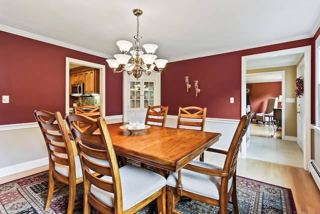 4 Adams Rd, Simsbury, CT 06089 - dining area with a chandelier, crown molding, baseboard heating, and light wood finished floors