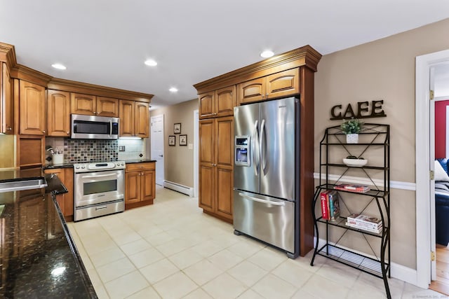 4 Adams Rd, Simsbury, CT 06089 - kitchen featuring appliances with stainless steel finishes, tasteful backsplash, dark stone countertops, a baseboard radiator, and brown cabinetry
