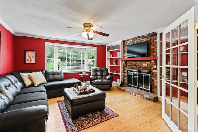 4 Adams Rd, Simsbury, CT 06089 - living room with a textured ceiling, a ceiling fan, ornamental molding, a fireplace, and hardwood / wood-style flooring