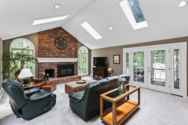 4 Adams Rd, Simsbury, CT 06089 - carpeted living area with a skylight, french doors, a brick fireplace, high vaulted ceiling, and recessed lighting