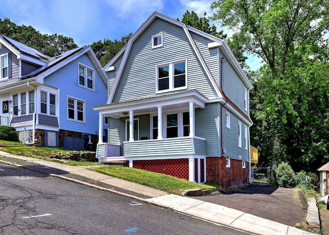 21 Orange Ter, West Haven, CT 06516 - view of front facade featuring covered porch, driveway, and a gambrel roof