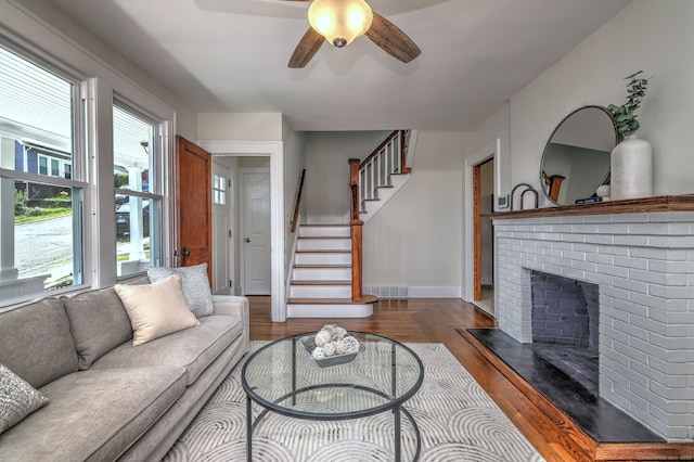 21 Orange Ter, West Haven, CT 06516 - living area featuring healthy amount of natural light, ceiling fan, a brick fireplace, and wood finished floors
