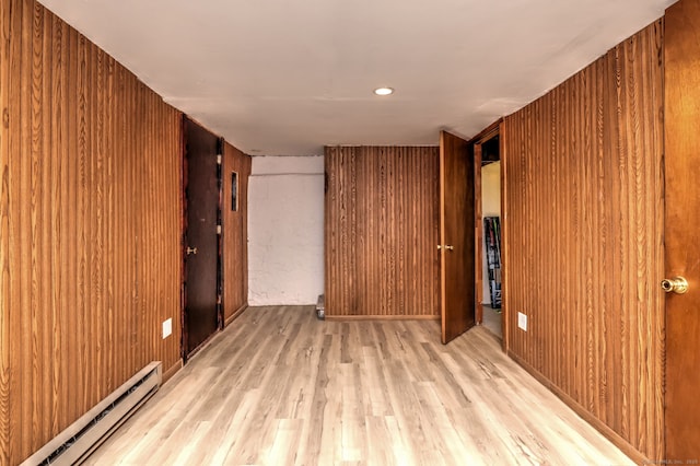 21 Orange Ter, West Haven, CT 06516 - unfurnished bedroom with baseboard heating, wood finished floors, and wooden walls