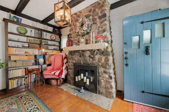 20 Cedar Crest Pl, Norwalk, CT 06854 - living area featuring wood-type flooring, a stone fireplace, and beamed ceiling