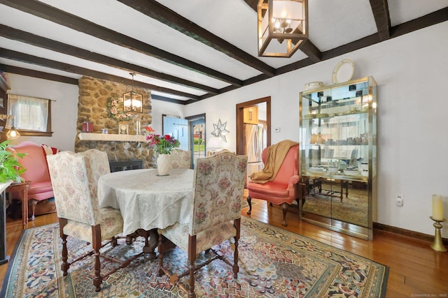 20 Cedar Crest Pl, Norwalk, CT 06854 - dining space with a chandelier, beamed ceiling, wood-type flooring, and a stone fireplace