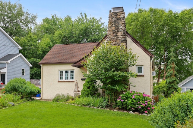 20 Cedar Crest Pl, Norwalk, CT 06854 - view of side of property featuring stucco siding, a lawn, and a chimney