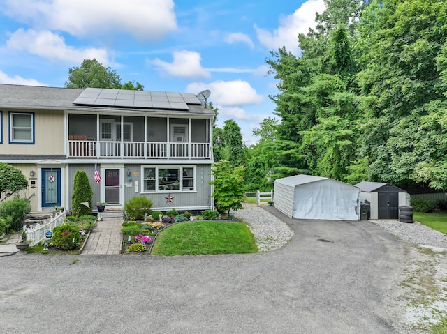7 Pheasant Run Rd Unit 1, Kent, CT 06757 - view of front of house featuring a storage shed, roof mounted solar panels, and a garage