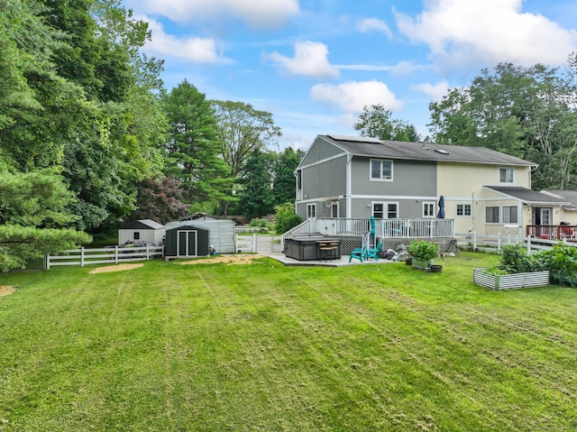 7 Pheasant Run Rd Unit 1, Kent, CT 06757 - back of property featuring a hot tub, a vegetable garden, a wooden deck, a storage unit, and a fenced backyard