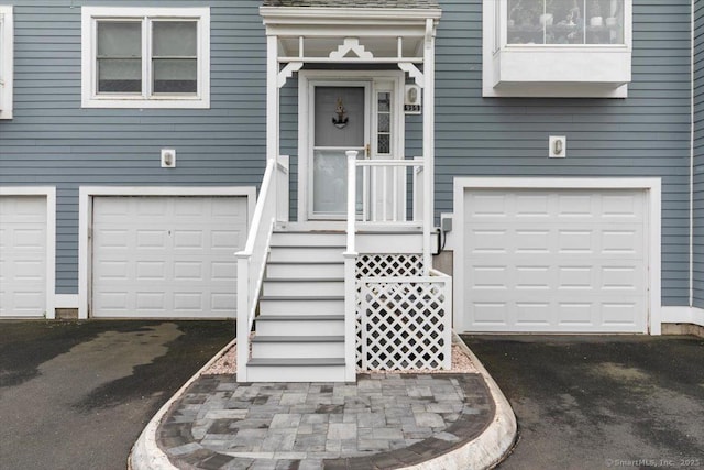 93 Cosey Beach Ave Apt 5, East Haven, CT 06512 - doorway to property with an attached garage and asphalt driveway