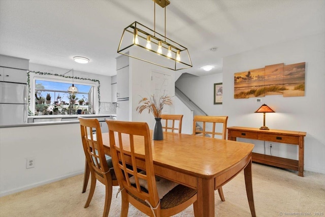 93 Cosey Beach Ave Apt 5, East Haven, CT 06512 - dining room with light carpet and baseboards