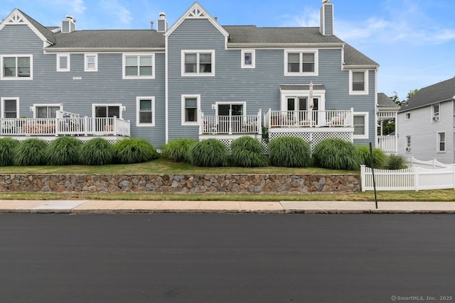 93 Cosey Beach Ave Apt 5, East Haven, CT 06512 - rear view of property with a chimney
