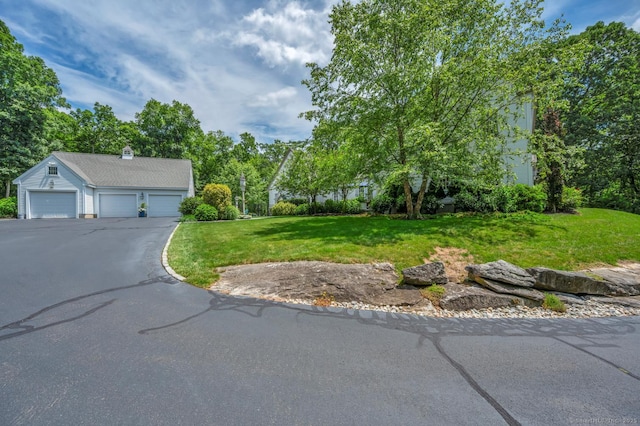 14 Ely Ln, Killingworth, CT 06419 - view of front of property with a front yard, a chimney, and asphalt driveway
