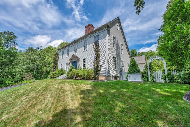 14 Ely Ln, Killingworth, CT 06419 - back of property featuring a chimney and a lawn