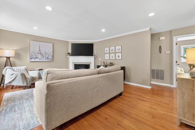 215 Georgetown Dr, Glastonbury, CT 06033 - living room featuring a fireplace, light wood-style flooring, recessed lighting, and ornamental molding
