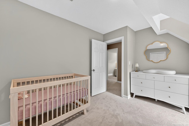 215 Georgetown Dr, Glastonbury, CT 06033 - carpeted bedroom featuring a skylight, a nursery area, and lofted ceiling