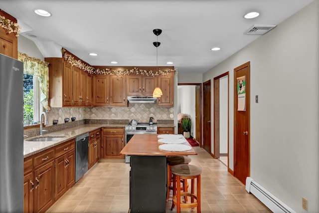 288 Pine Ln, Wethersfield, CT 06109 - kitchen with baseboard heating, appliances with stainless steel finishes, under cabinet range hood, decorative backsplash, and brown cabinets