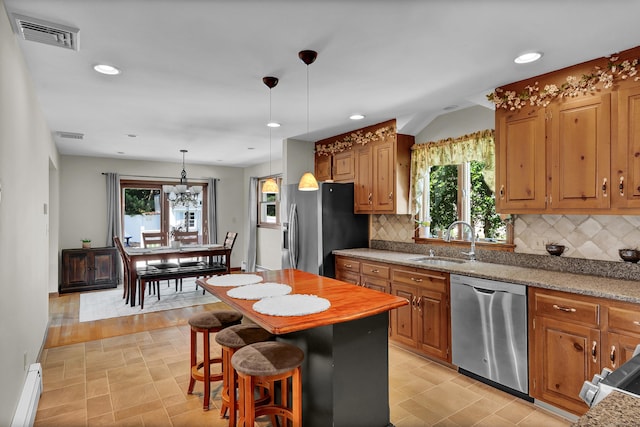 288 Pine Ln, Wethersfield, CT 06109 - kitchen with appliances with stainless steel finishes, a baseboard heating unit, decorative backsplash, recessed lighting, and pendant lighting