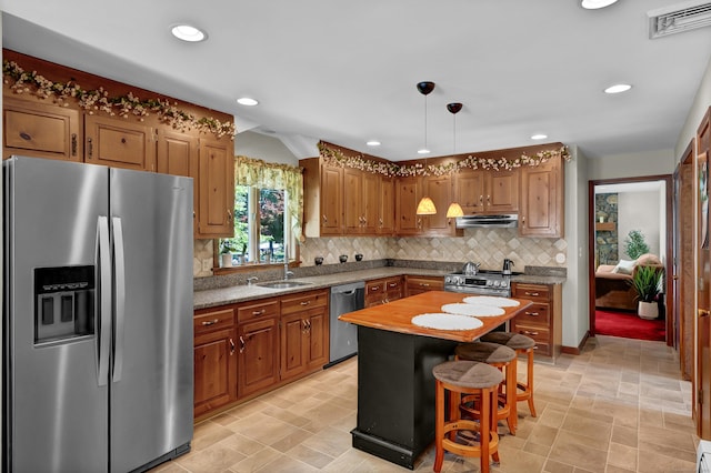 288 Pine Ln, Wethersfield, CT 06109 - kitchen featuring appliances with stainless steel finishes, tasteful backsplash, recessed lighting, under cabinet range hood, and hanging light fixtures