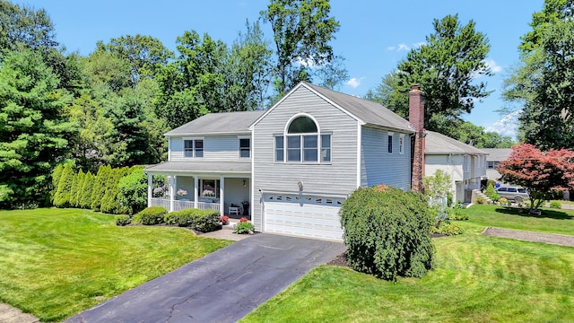 288 Pine Ln, Wethersfield, CT 06109 - view of front of house featuring a porch, asphalt driveway, a garage, a front lawn, and a chimney