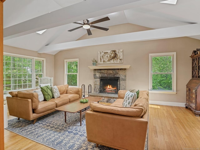 119 Deforest Rd, Wilton, CT 06897 - living area with wood finished floors, a stone fireplace, vaulted ceiling, and a ceiling fan