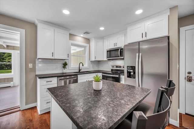 2 Riverview Pl, Cromwell, CT 06416 - kitchen with stainless steel appliances, dark countertops, tasteful backsplash, white cabinetry, and recessed lighting