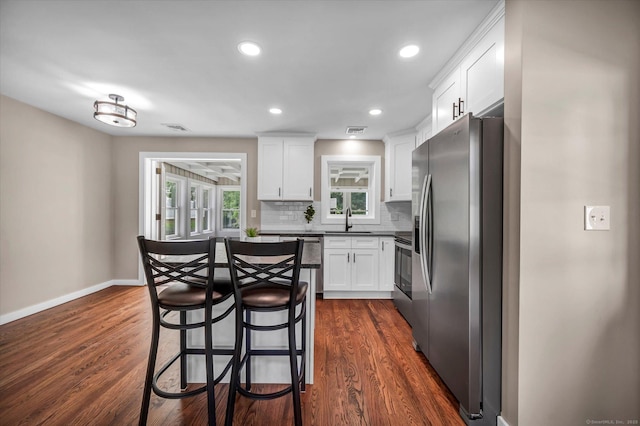 2 Riverview Pl, Cromwell, CT 06416 - kitchen featuring stainless steel appliances, white cabinetry, backsplash, dark wood finished floors, and recessed lighting
