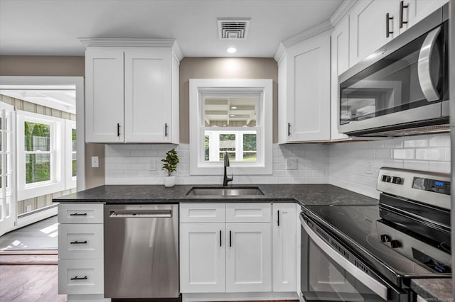 2 Riverview Pl, Cromwell, CT 06416 - kitchen featuring stainless steel appliances, healthy amount of natural light, white cabinetry, decorative backsplash, and recessed lighting