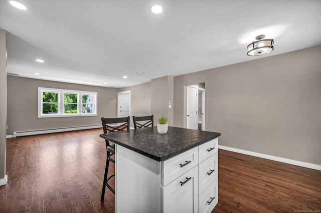 2 Riverview Pl, Cromwell, CT 06416 - kitchen with a baseboard heating unit, a kitchen bar, open floor plan, white cabinets, and dark wood finished floors