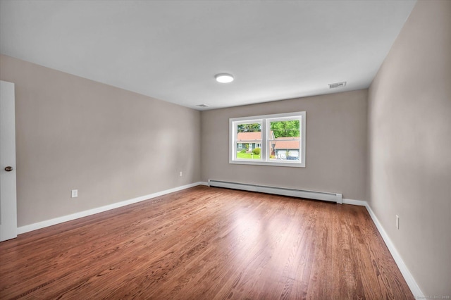 2 Riverview Pl, Cromwell, CT 06416 - empty room featuring a baseboard heating unit and wood finished floors