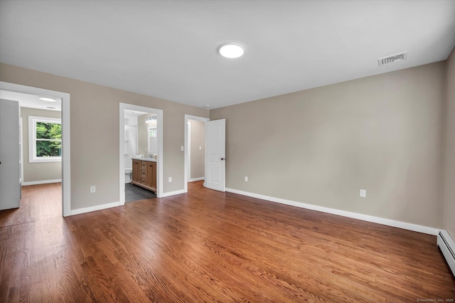 2 Riverview Pl, Cromwell, CT 06416 - unfurnished bedroom featuring dark wood finished floors, a baseboard heating unit, and ensuite bath