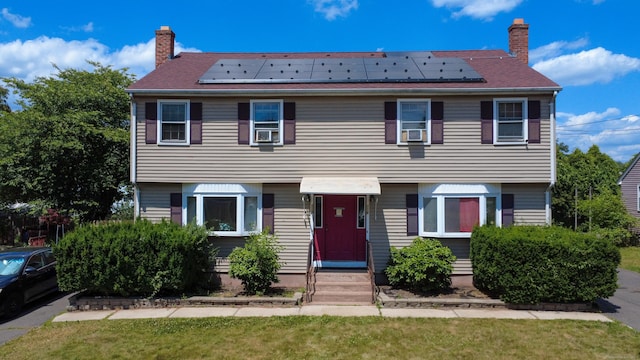 116 Michael Ave, East Hartford, CT 06108 - view of front of property featuring a chimney and roof mounted solar panels
