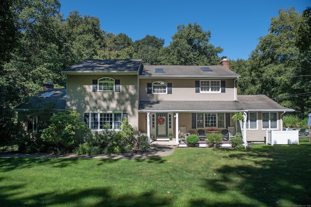 172 Mimosa Cir, Ridgefield, CT 06877 - view of front of house with a chimney, a front yard, a sunroom, and covered porch