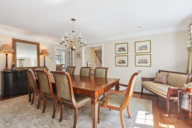 172 Mimosa Cir, Ridgefield, CT 06877 - dining area featuring a chandelier, wood finished floors, ornamental molding, and stairs