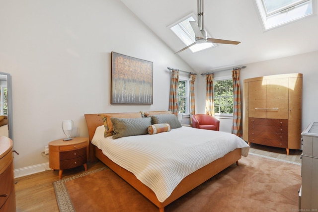 172 Mimosa Cir, Ridgefield, CT 06877 - bedroom featuring a skylight, light wood-type flooring, high vaulted ceiling, and ceiling fan