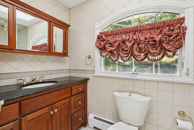 172 Mimosa Cir, Ridgefield, CT 06877 - half bath with a baseboard radiator, tile walls, vanity, and plenty of natural light